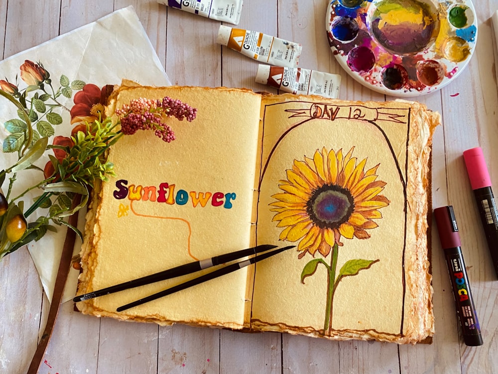 a book with a sunflower drawn on it