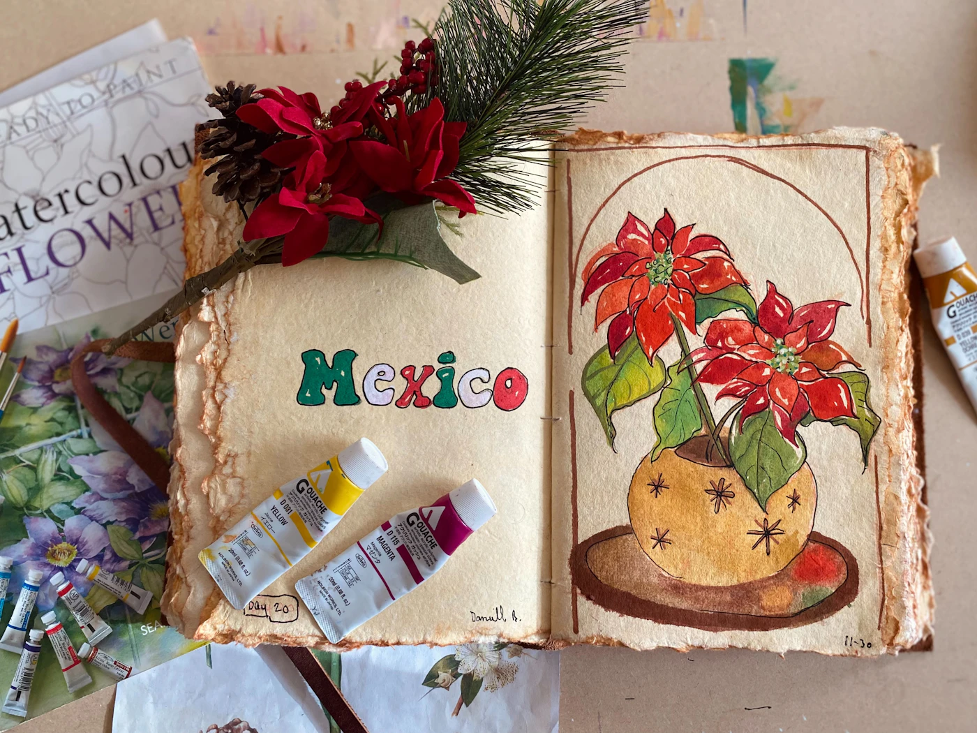 Painting of a flower in a pot on a book