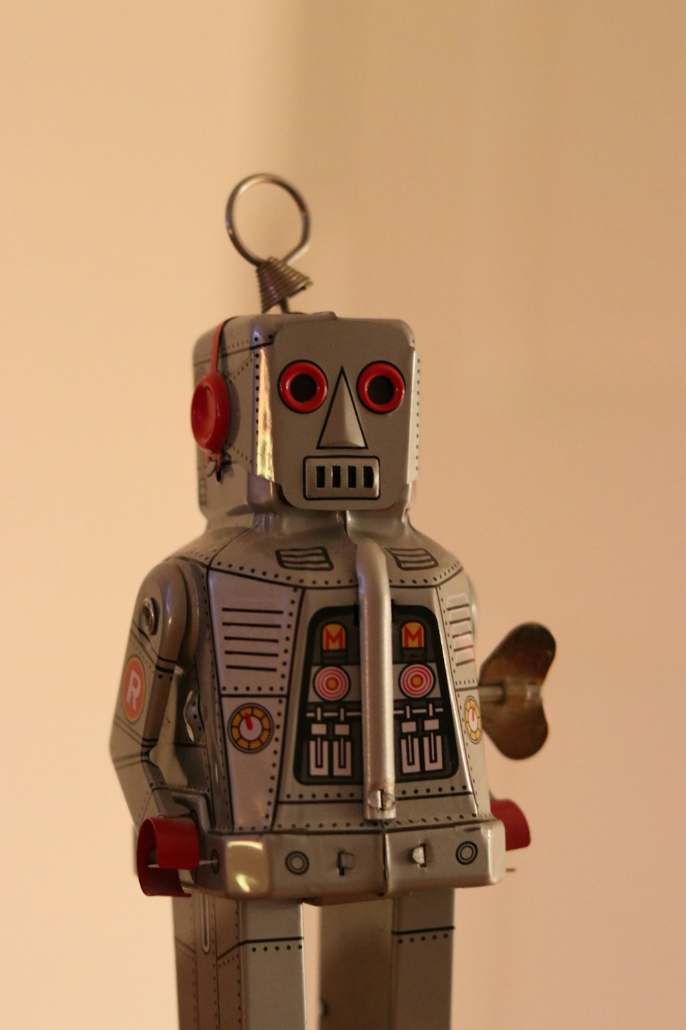 a metal robot with red eyes and a red nose