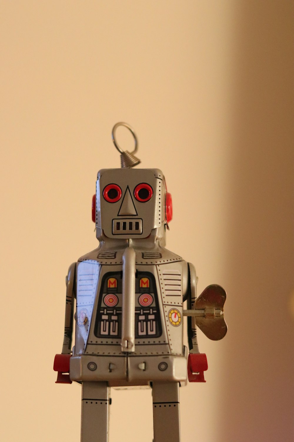 a toy robot holding a piece of paper