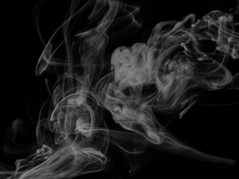 a black and white photo of smoke on a black background