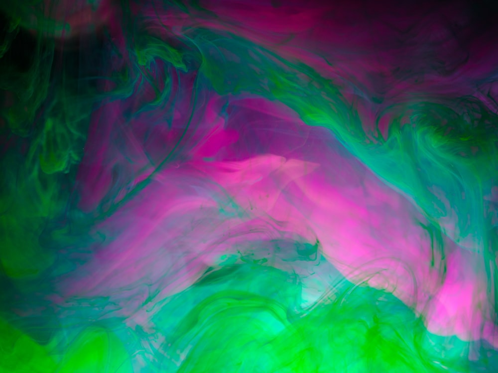 an abstract painting of green, pink, and blue