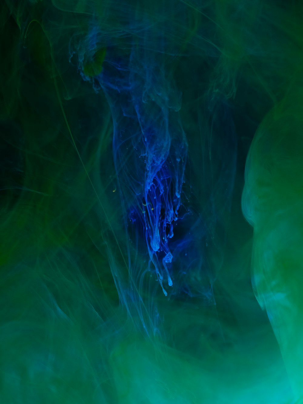 a close up of a blue and green substance