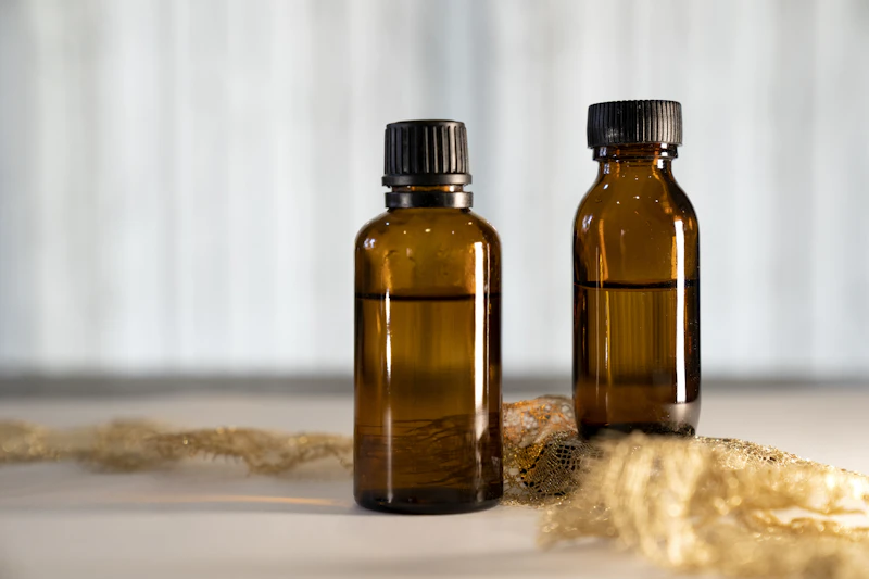 Amber dropper bottles with dried herbs in soft natural light