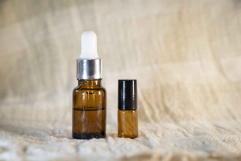 a bottle of essential oil next to a small bottle of essential oil