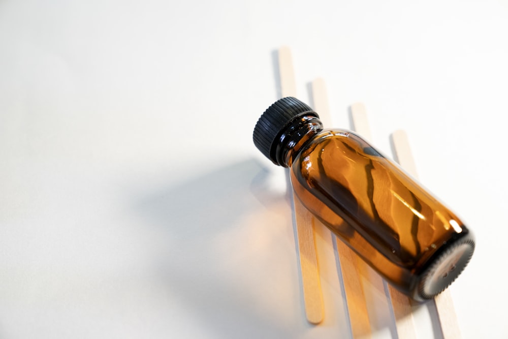 a brown bottle sitting on top of a white table