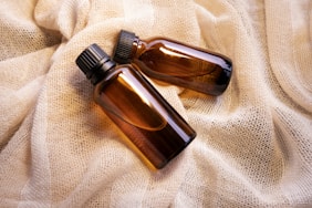 a couple of brown bottles sitting on top of a bed