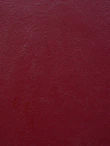 a close up of a red wall with a white clock on it