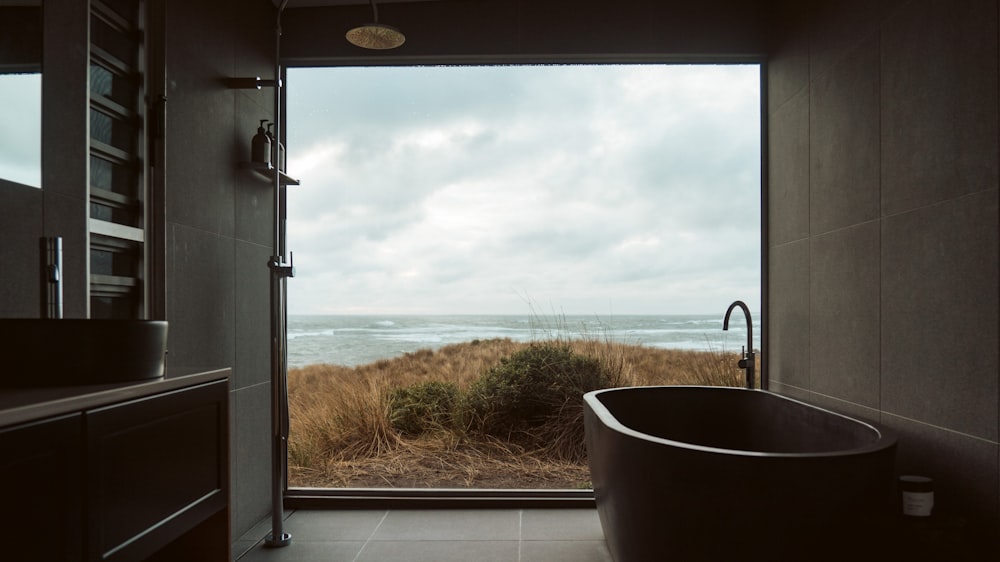 a bath tub sitting in a bathroom next to a window