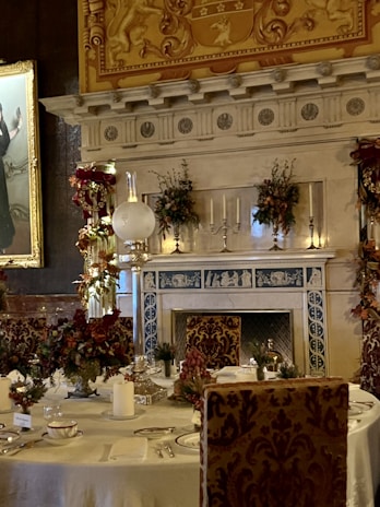 a dining room with a fireplace and a painting on the wall