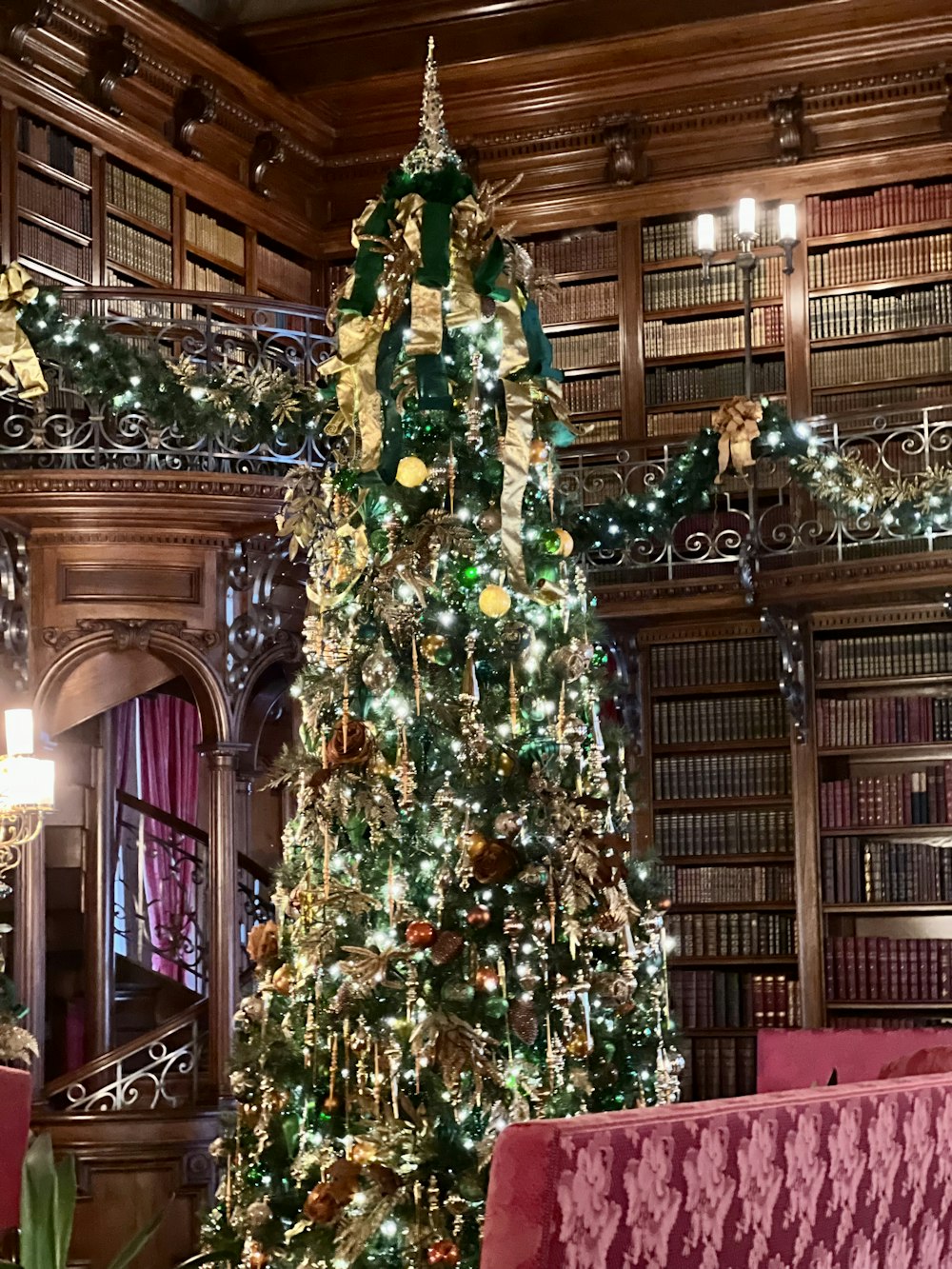 a decorated christmas tree in a library