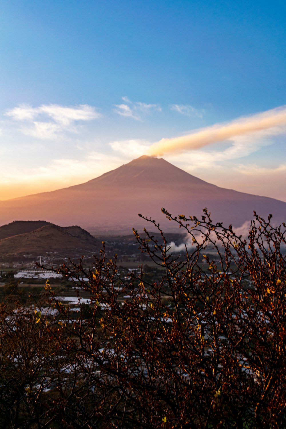 a view of a mountain with a cloud in the sky