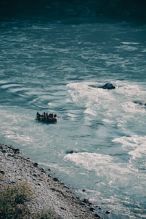 a group of people floating on top of a body of water