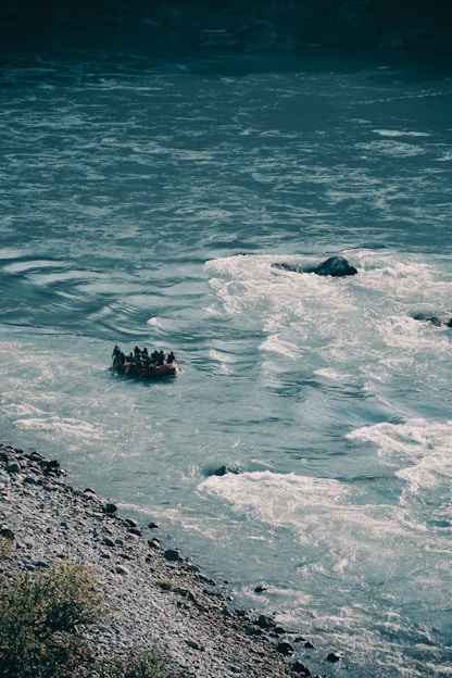 a group of people floating on top of a body of water