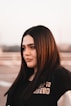 a woman with long hair and a black shirt