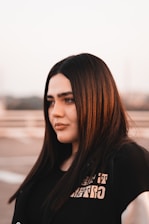 a woman with long hair and a black shirt