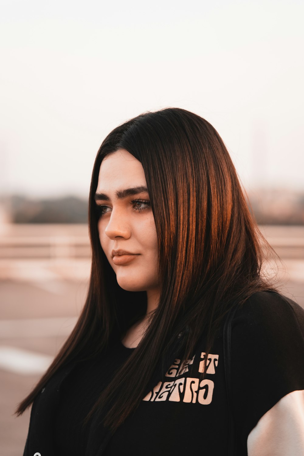 a woman with long hair and a black shirt