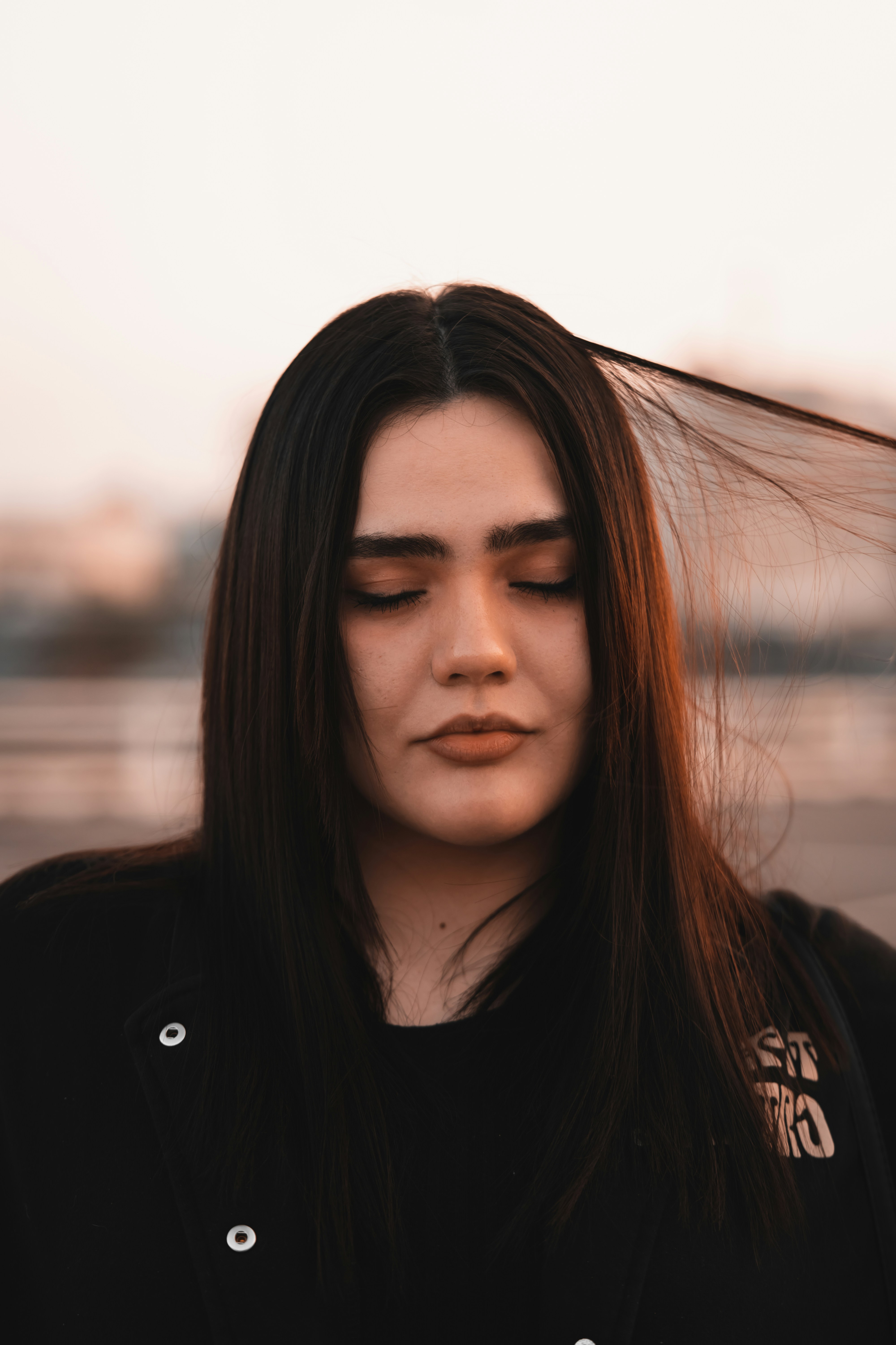 woman with dark hair flowing in the wind