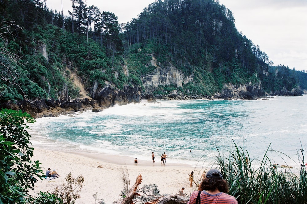 a person sitting on the beach looking out at the water