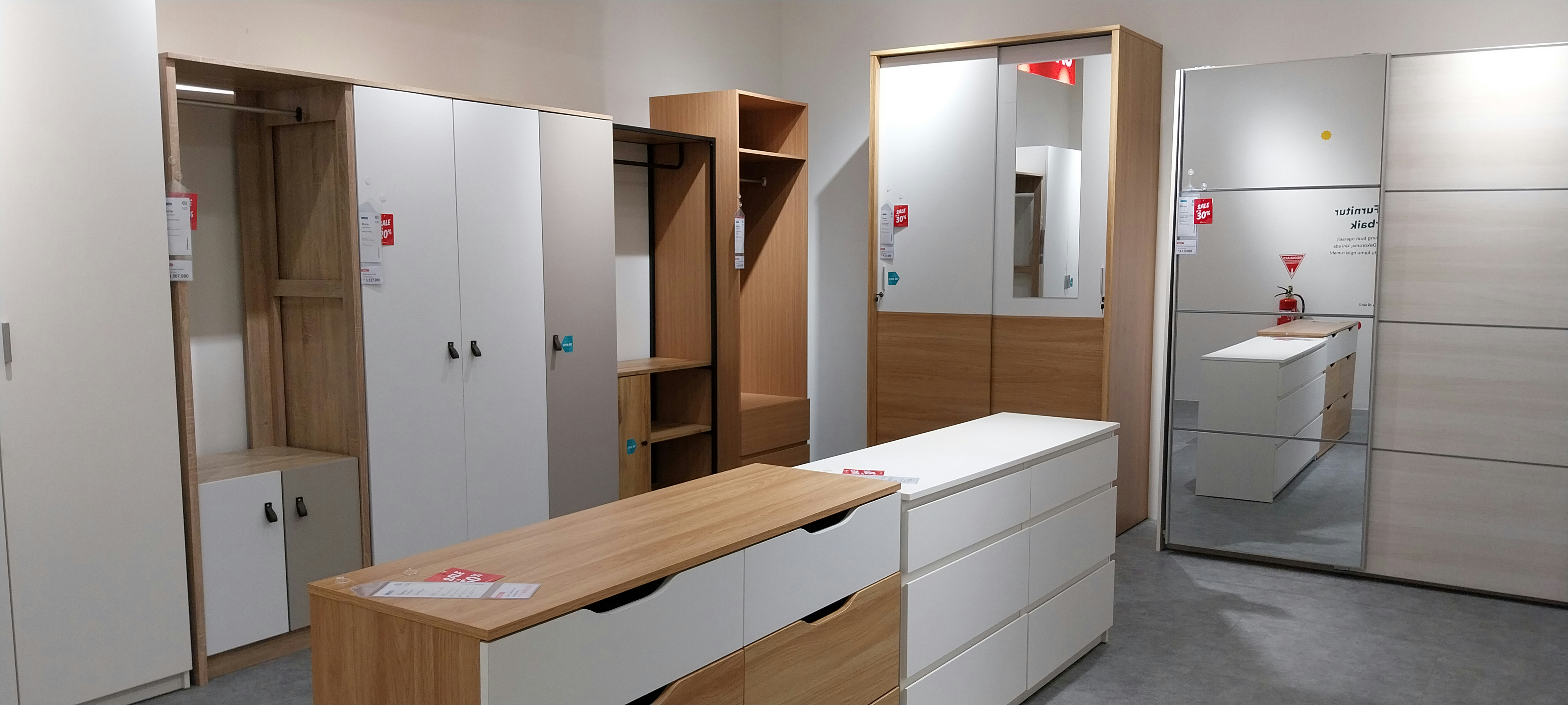 a room filled with lots of white cabinets