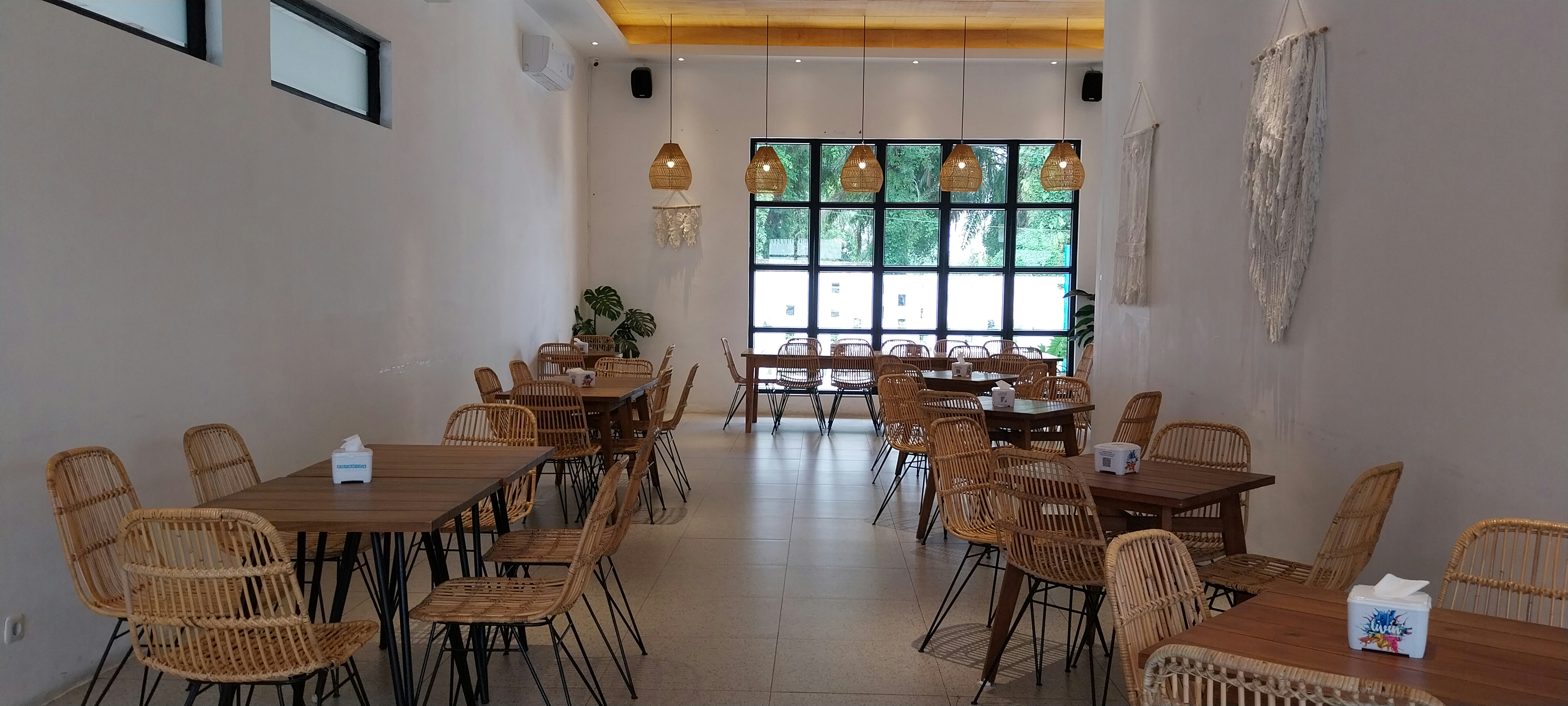 a restaurant with wicker tables and chairs
