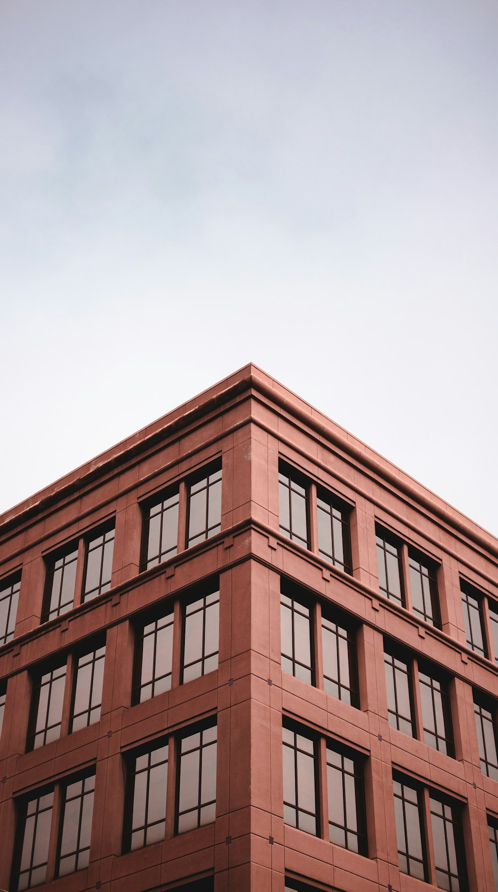 a tall red building with lots of windows