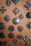 Close-up of colorful vintage-style enamel badges arranged on a wooden surface.