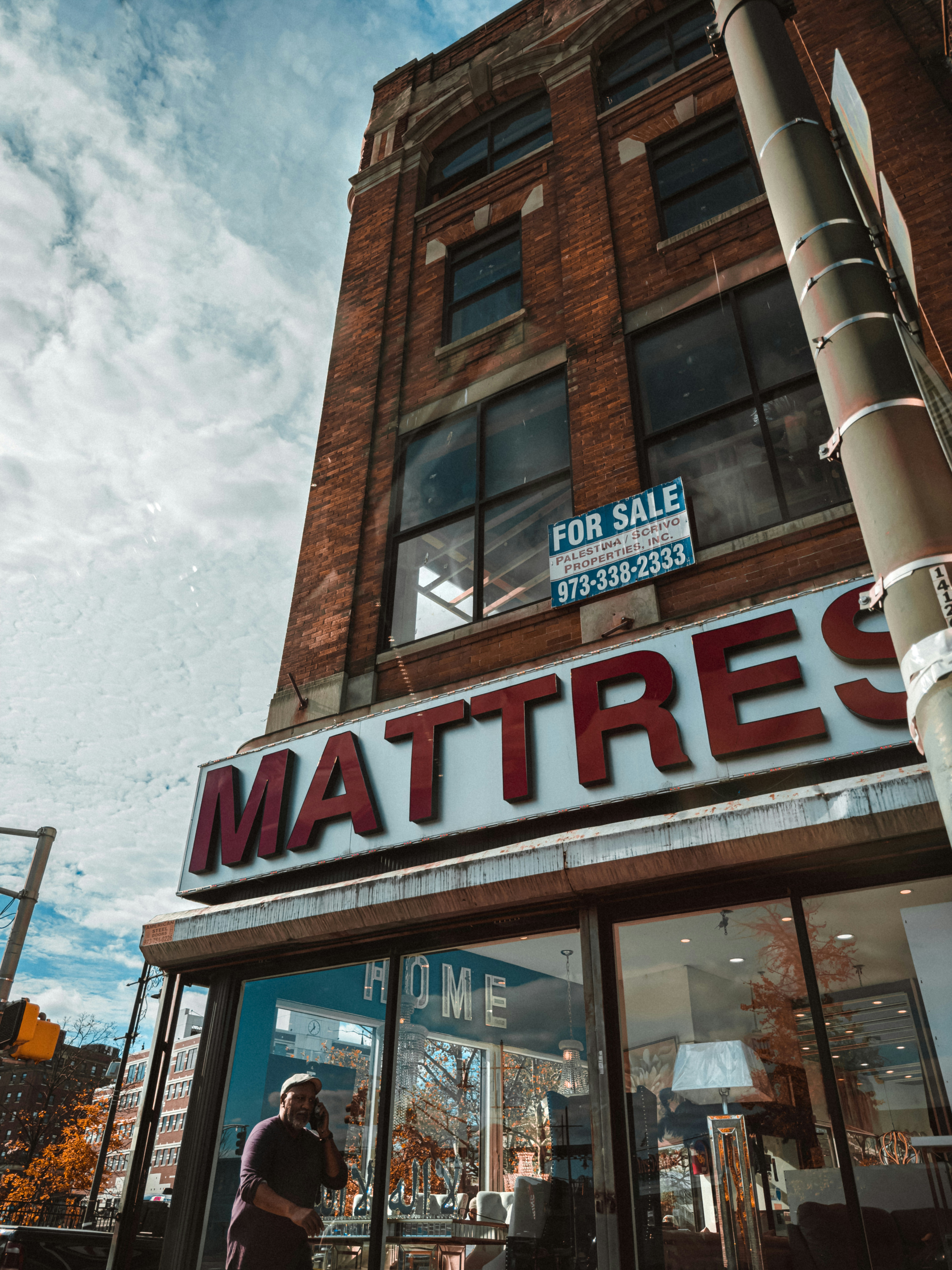 a tall building with a sign that says mattress on it