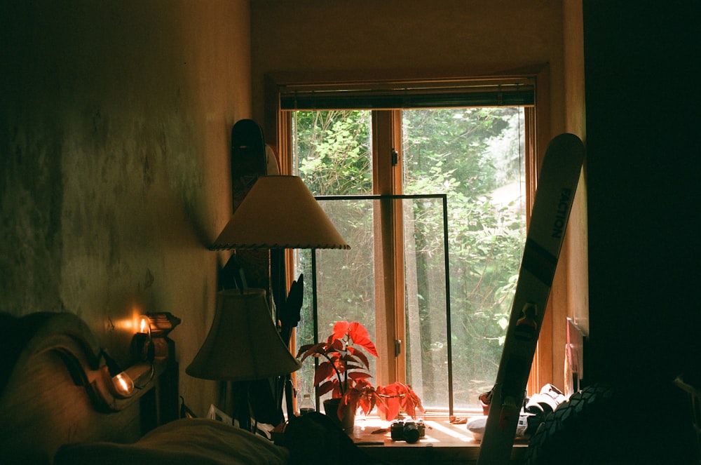 a bedroom with a lamp and a window