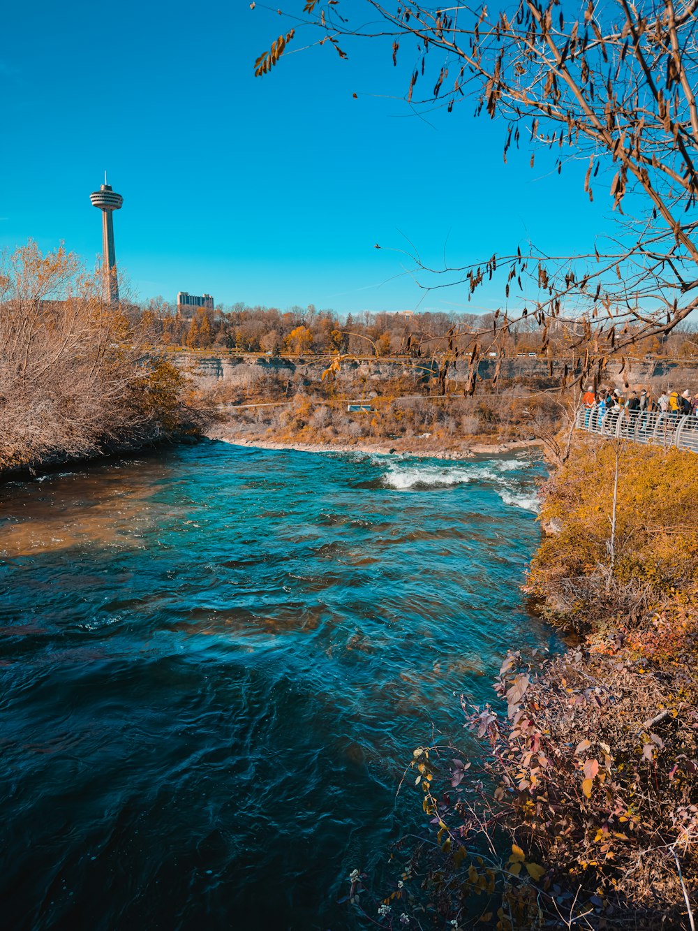 a body of water with a light house in the background