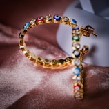 A close-up of intricate gold earrings with gemstones.
