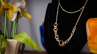 Close-up of a sleek 14k gold chain resting on black velvet.