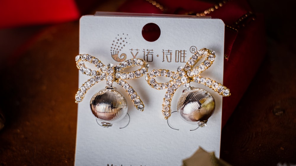 a close up of a pair of earrings on a card