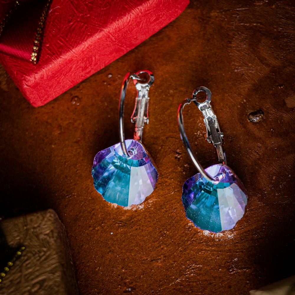 a pair of earrings sitting on top of a table