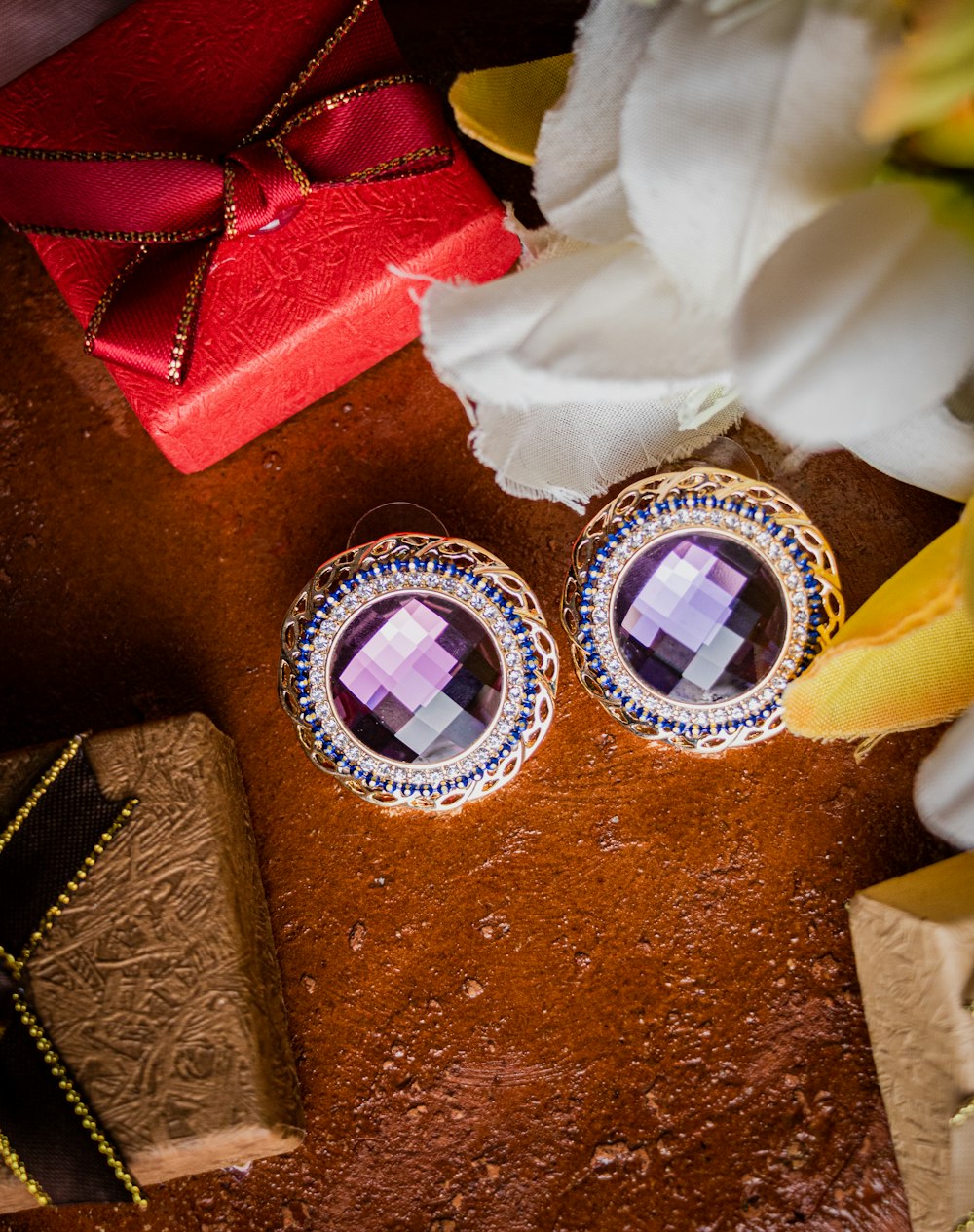 a pair of earrings sitting on top of a table