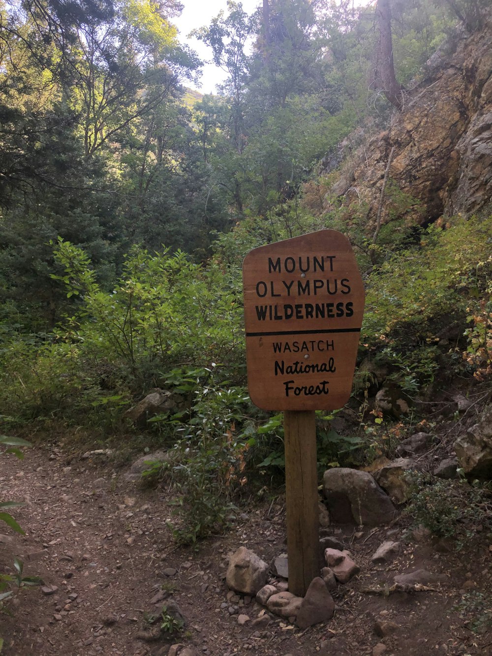 a sign that is on the side of a dirt road