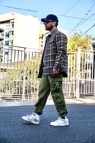A candid shot of a man walking outdoors in a stylish jacket from the brand's sustainable line.