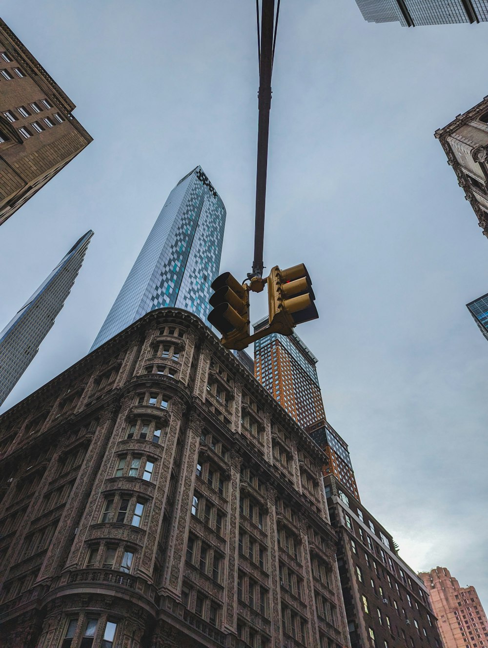 a traffic light hanging from the side of a tall building