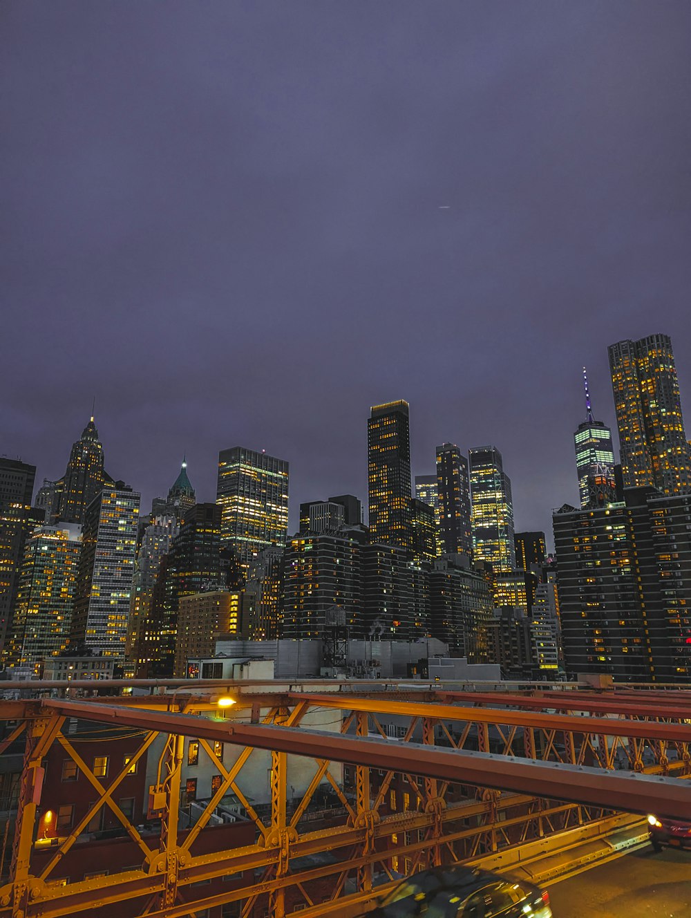 a view of a city at night from a bridge