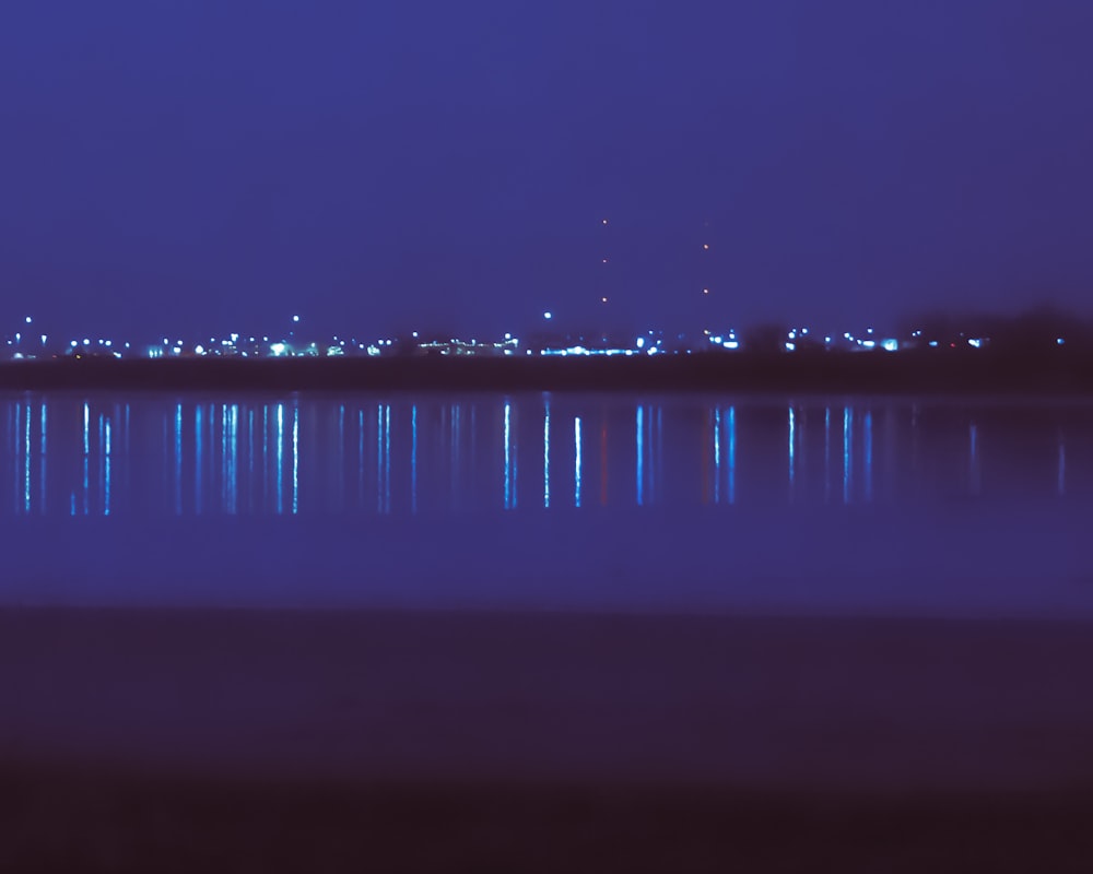 a large body of water with a city in the background