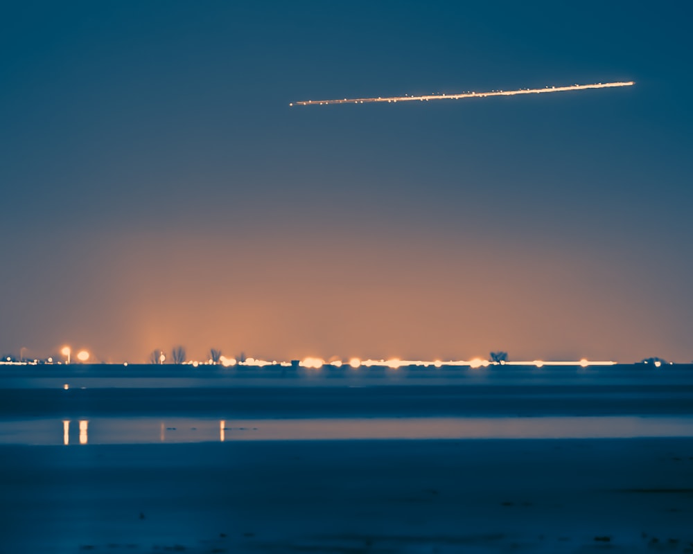 an airplane flying over a city at night