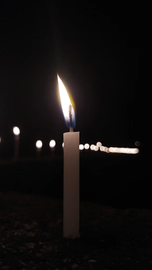 A serene photo of a softly lit memorial box surrounded by gentle candlelight.