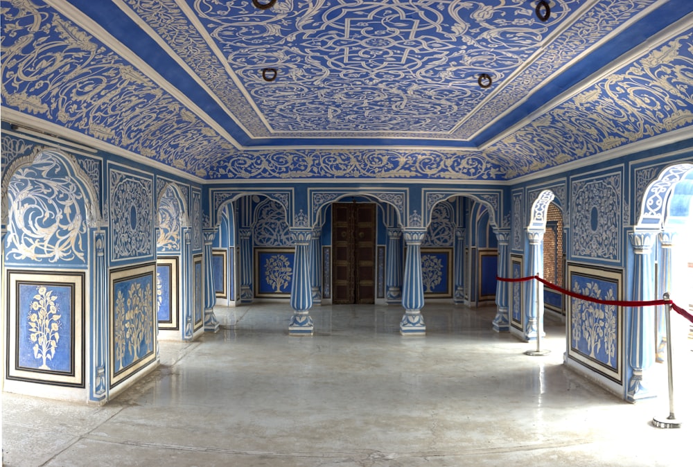 a room with blue and white walls and a red rope