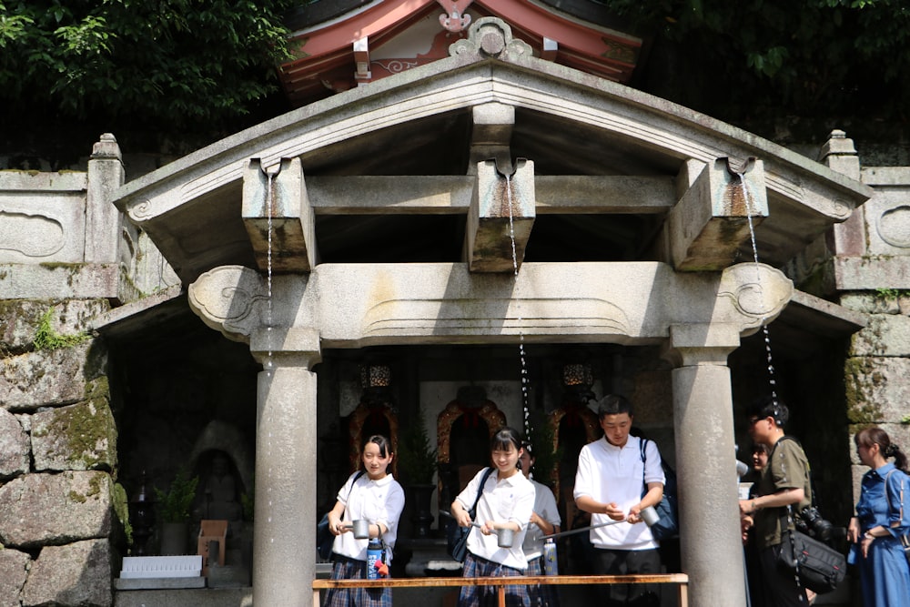 a group of people that are standing in front of a building