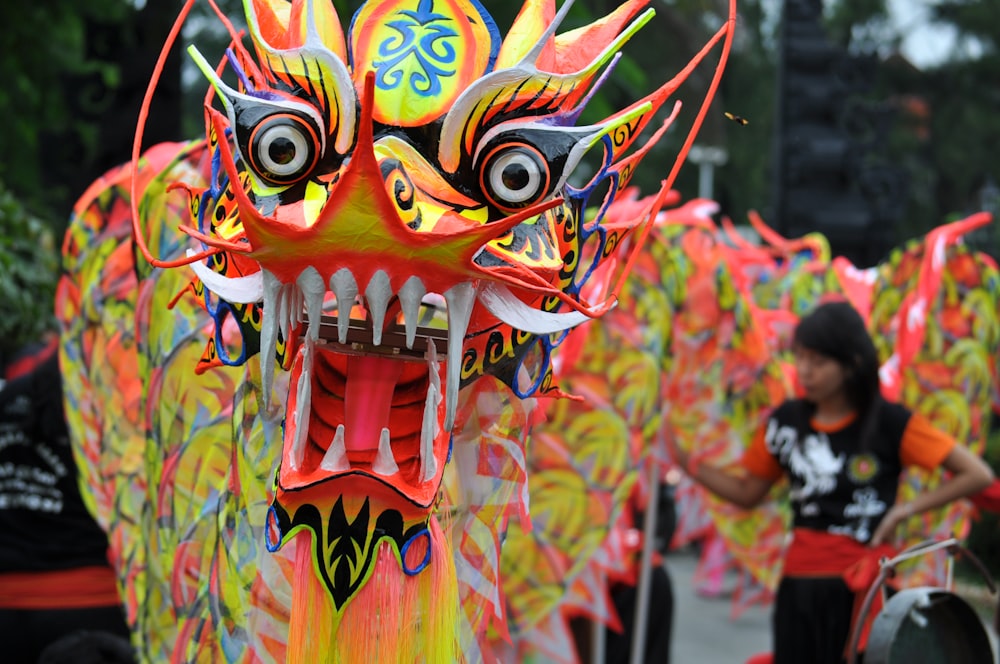 a group of people standing around a dragon statue