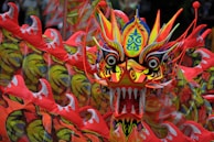 Bold mascot design featuring a stylized dragon with sharp lines and vivid colors.