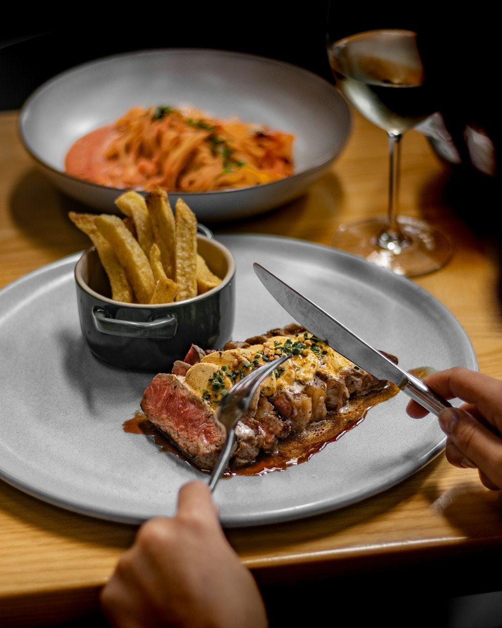 a person cutting a piece of food on a plate