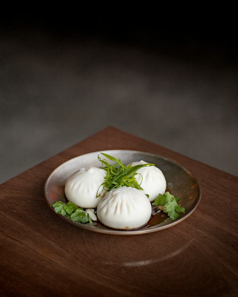a plate of dumplings on a wooden table