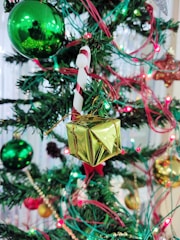 A beautifully decorated Christmas tree surrounded by gifts.
