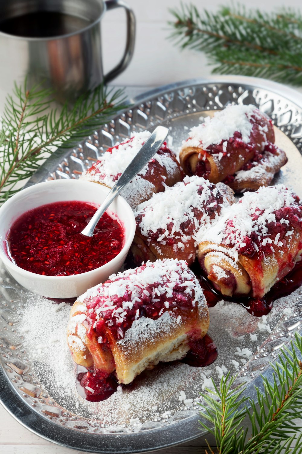 a plate of pastries with powdered sugar on top